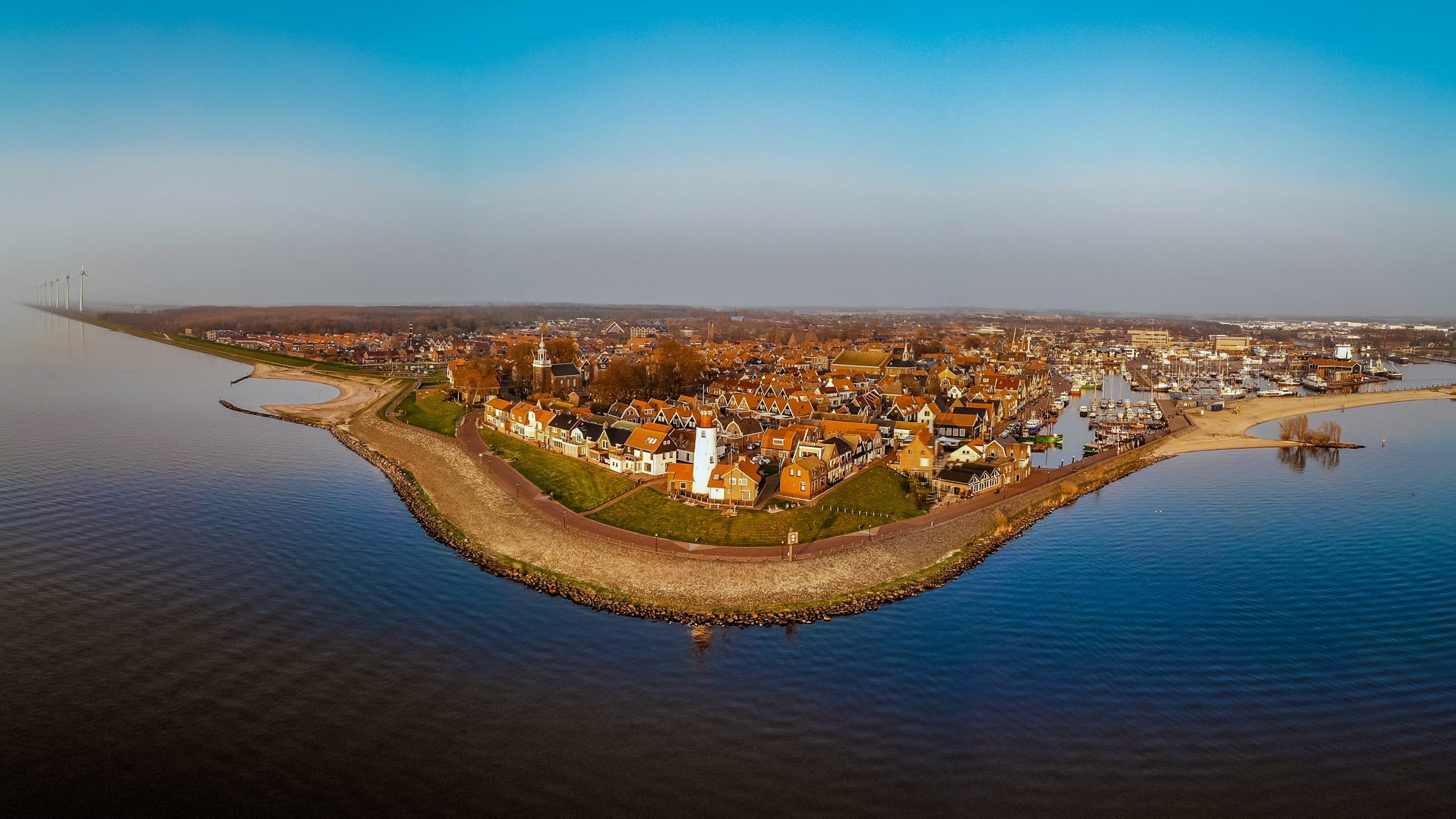 Sunset over the harbour and lighthouse at Urk, the Netherlands