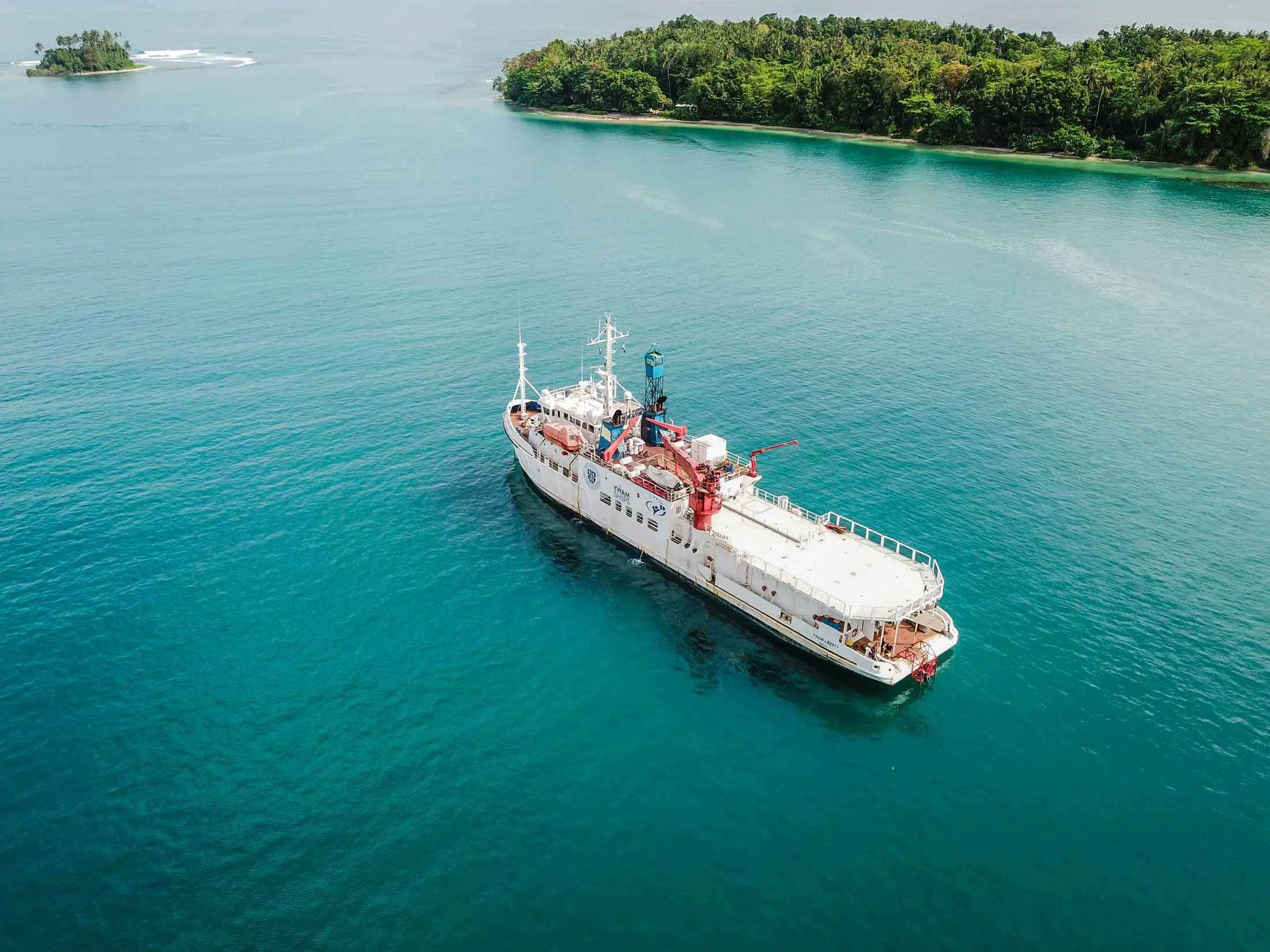 A YWAM medical ship anchored off a tropical island in Papua New Guinea